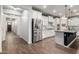 Modern kitchen featuring stainless steel appliances, white cabinetry, herringbone backsplash, and a black island at 19982 W Glenrosa Ave, Litchfield Park, AZ 85340