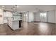 Open-concept kitchen and living area with wood-look floors and ample natural light from large windows at 19982 W Glenrosa Ave, Litchfield Park, AZ 85340