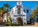 Two story market with arched entry and palm trees at 19982 W Glenrosa Ave, Litchfield Park, AZ 85340