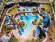 Aerial view of an amazing resort-style pool with lush landscaping, cabanas, and plenty of lounge chairs at 19982 W Glenrosa Ave, Litchfield Park, AZ 85340