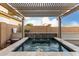 Tranquil pool with integrated spa and decorative water feature, set under a stylish pergola at 19982 W Glenrosa Ave, Litchfield Park, AZ 85340