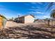 Expansive backyard with gravel landscaping, chain-link fence, and a charming single-story home at 200 E Hess Ave, Coolidge, AZ 85128