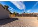 Large backyard featuring gravel landscaping, a weathered fence, and a clear view of the sky at 200 E Hess Ave, Coolidge, AZ 85128