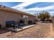 Backyard patio area featuring outdoor seating and a barbecue grill, perfect for outdoor dining at 200 E Hess Ave, Coolidge, AZ 85128