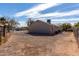 Spacious backyard with gravel, secured with chain-link and wood fences, offering ample space at 200 E Hess Ave, Coolidge, AZ 85128