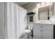 Well-lit bathroom featuring vanity and a shower curtain at 200 E Hess Ave, Coolidge, AZ 85128