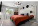 Spacious bedroom featuring a ceiling fan, natural light, and a large mirror at 200 E Hess Ave, Coolidge, AZ 85128