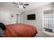 Relaxing bedroom with mounted tv and ensuite bathroom at 200 E Hess Ave, Coolidge, AZ 85128