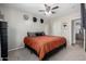 Cozy bedroom featuring neutral tones, hats for decor, and ceiling fan at 200 E Hess Ave, Coolidge, AZ 85128