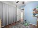 Bedroom featuring soothing blue walls, a grey rug, and a soft play area at 200 E Hess Ave, Coolidge, AZ 85128