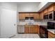 Efficient kitchen featuring wood cabinetry, stainless steel appliances, and modern fixtures at 200 E Hess Ave, Coolidge, AZ 85128