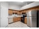 Efficient kitchen featuring wood cabinetry, stainless steel appliances, and modern fixtures at 200 E Hess Ave, Coolidge, AZ 85128