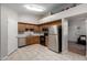 Efficient kitchen featuring wood cabinetry, stainless steel appliances, and modern fixtures at 200 E Hess Ave, Coolidge, AZ 85128