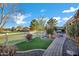 A meticulously landscaped backyard with a paved walkway leading to a fire pit for memorable outdoor entertaining at 20391 N Sunrise Ln, Maricopa, AZ 85138