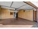 Spacious garage with storage cabinets along the walls, a garage door opener and epoxy floor at 20391 N Sunrise Ln, Maricopa, AZ 85138