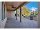 Spacious covered patio with stone flooring, a built-in grill and a cozy fire pit at 20391 N Sunrise Ln, Maricopa, AZ 85138