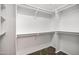 A walk-in closet with multiple shelves and rods for storage at 20391 N Sunrise Ln, Maricopa, AZ 85138