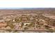 An aerial view showcases a neighborhood nestled in a desert landscape at 2070 W Bromm Ln, Wickenburg, AZ 85390