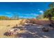 Landscaped backyard featuring a fountain and fire pit at 2070 W Bromm Ln, Wickenburg, AZ 85390