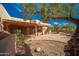 Charming courtyard with stone accents and a covered patio offers a serene outdoor space at 2070 W Bromm Ln, Wickenburg, AZ 85390