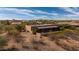 A single story home featuring a red tile roof in an arid desert landscape at 2070 W Bromm Ln, Wickenburg, AZ 85390