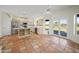 Open concept kitchen features terra cotta tile, white cabinets, and stainless steel appliances at 2070 W Bromm Ln, Wickenburg, AZ 85390