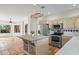 Charming kitchen with a central island and stainless steel appliances, filled with sunlight at 2070 W Bromm Ln, Wickenburg, AZ 85390