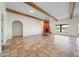 Large living area featuring beamed ceilings, a fireplace, and tile flooring throughout at 2070 W Bromm Ln, Wickenburg, AZ 85390