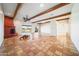 Spacious living room with exposed beams, Saltillo tile flooring, and a corner fireplace at 2070 W Bromm Ln, Wickenburg, AZ 85390