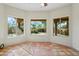 Sun room featuring terra cotta tile floors and large windows with exterior views at 2070 W Bromm Ln, Wickenburg, AZ 85390