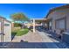 Wide backyard with a covered patio, storage shed, and landscaped with artificial turf at 214 N 222Nd Dr, Buckeye, AZ 85326