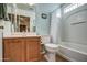 Cozy bathroom featuring a shower-tub combo, a vanity with storage, and neutral-toned walls at 214 N 222Nd Dr, Buckeye, AZ 85326