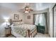 Traditional bedroom featuring a bed, a bedside table, and tiled floors at 214 N 222Nd Dr, Buckeye, AZ 85326