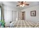 Well-lit bedroom featuring a ceiling fan, closet, and neutral decor at 214 N 222Nd Dr, Buckeye, AZ 85326