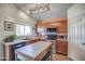 Well-lit kitchen showcasing stainless steel appliances, sleek countertops, and a functional island at 214 N 222Nd Dr, Buckeye, AZ 85326