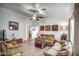 Comfortable living room showcasing neutral walls, tile flooring, and stylish furnishings at 214 N 222Nd Dr, Buckeye, AZ 85326