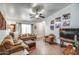 Inviting living room with large windows, ceiling fan, and traditional decor at 214 N 222Nd Dr, Buckeye, AZ 85326