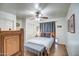 Relaxing bedroom with a ceiling fan, tiled floors, and neutral-toned walls at 214 N 222Nd Dr, Buckeye, AZ 85326