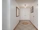 Bright hallway featuring neutral paint, tile floor, and decorative mirror at 2143 W Eugie Ave, Phoenix, AZ 85029