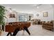 Bright living area showcasing a game table, a comfortable sofa, and a decorative plant at 2143 W Eugie Ave, Phoenix, AZ 85029