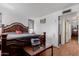 Main bedroom with a decorative bed frame, warm lighting, and access to the bathroom at 2143 W Eugie Ave, Phoenix, AZ 85029