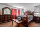 Luxurious main bedroom featuring an ornate bed frame and matching dresser with a mirror at 2143 W Eugie Ave, Phoenix, AZ 85029