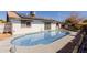 Backyard with a pool, patio, and solar panels, perfect for outdoor enjoyment at 2143 W Eugie Ave, Phoenix, AZ 85029