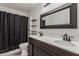 Bathroom with dual sinks, dark wood vanity, and decorative mirror at 2190 W San Tan Hills Dr, San Tan Valley, AZ 85144