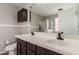 Bathroom features dual sinks, dark cabinets and tiled backsplash with a large mirror at 2190 W San Tan Hills Dr, San Tan Valley, AZ 85144