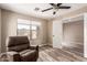 Relaxing bedroom with wood floors, a fan and a large window with neighborhood views at 2190 W San Tan Hills Dr, San Tan Valley, AZ 85144