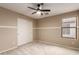 Bright bedroom featuring a ceiling fan, window and sliding door closet at 2190 W San Tan Hills Dr, San Tan Valley, AZ 85144