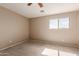 Bright bedroom with neutral walls, plush carpeting, and a large window overlooking the neighborhood at 2190 W San Tan Hills Dr, San Tan Valley, AZ 85144