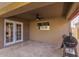 Cozy covered patio with stone flooring, ceiling fan, and a view of the backyard at 2190 W San Tan Hills Dr, San Tan Valley, AZ 85144