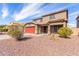 Two-story home with desert landscaping, a red garage door, and a tile roof at 2190 W San Tan Hills Dr, San Tan Valley, AZ 85144